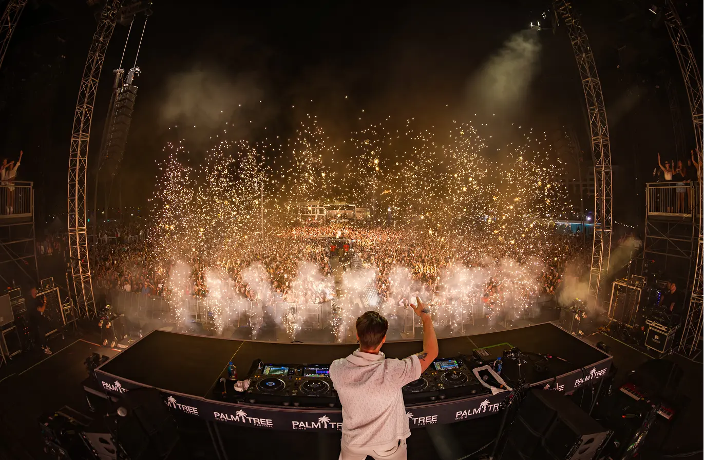 dj-performing-stage-pyrotechnics-festival-crowd